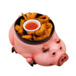 Lágrimas de solomillo de pollo caseras servidas en un cuenco de cerámica en forma de cerdo, con salsa de acompañamiento.